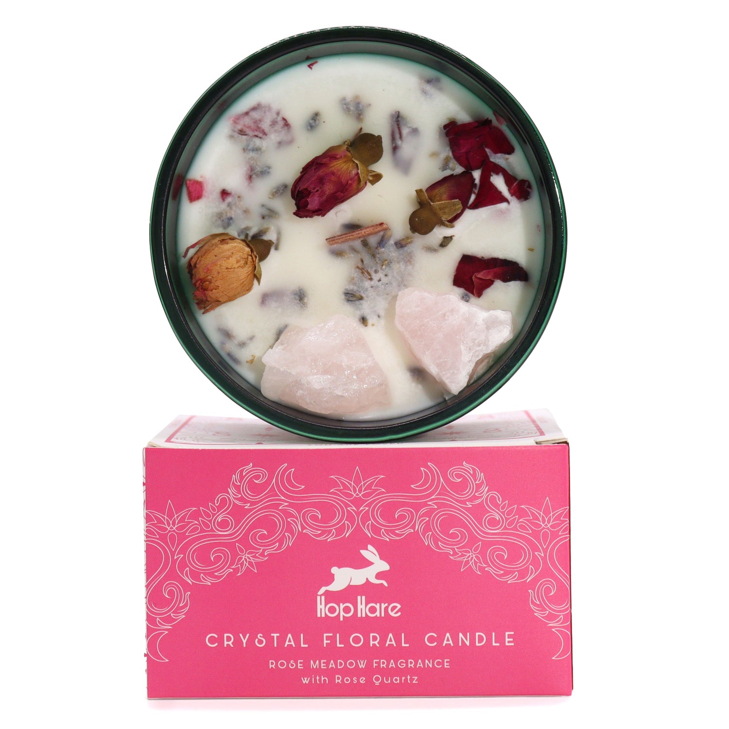 Candle in dark green jar with rose quartz crystals and dried rose petals on soy wax.