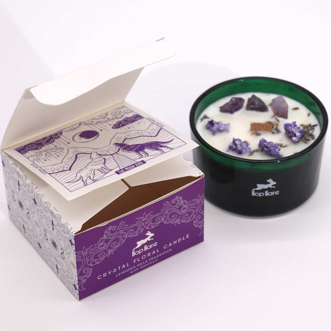 Crystal floral candle with decorative stones in a branded box on a white background