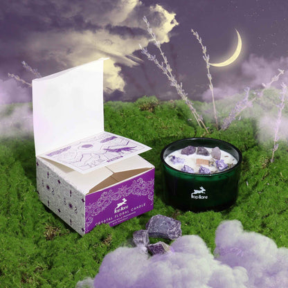Crystal filled candle with packaging on a grassy field under a moonlit sky