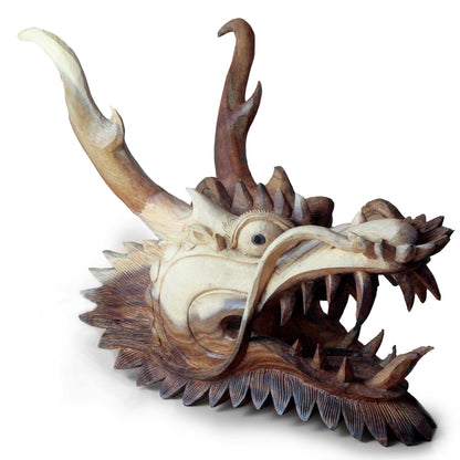 Wooden dragon head sculpture on a white background