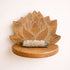 Wooden lotus-shaped shelf with a bundle of incense on a beige background