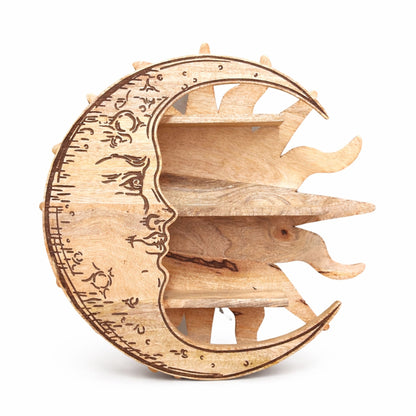 Wooden decorative shelf unit shaped like a crescent moon with engraved faces on a white background