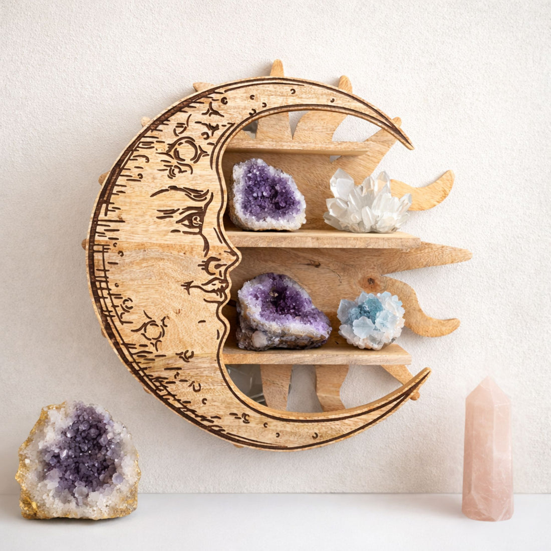 Wooden moon-shaped shelf with crystals on a light background