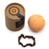 A bath bomb and bracelet with branded packaging on a white background