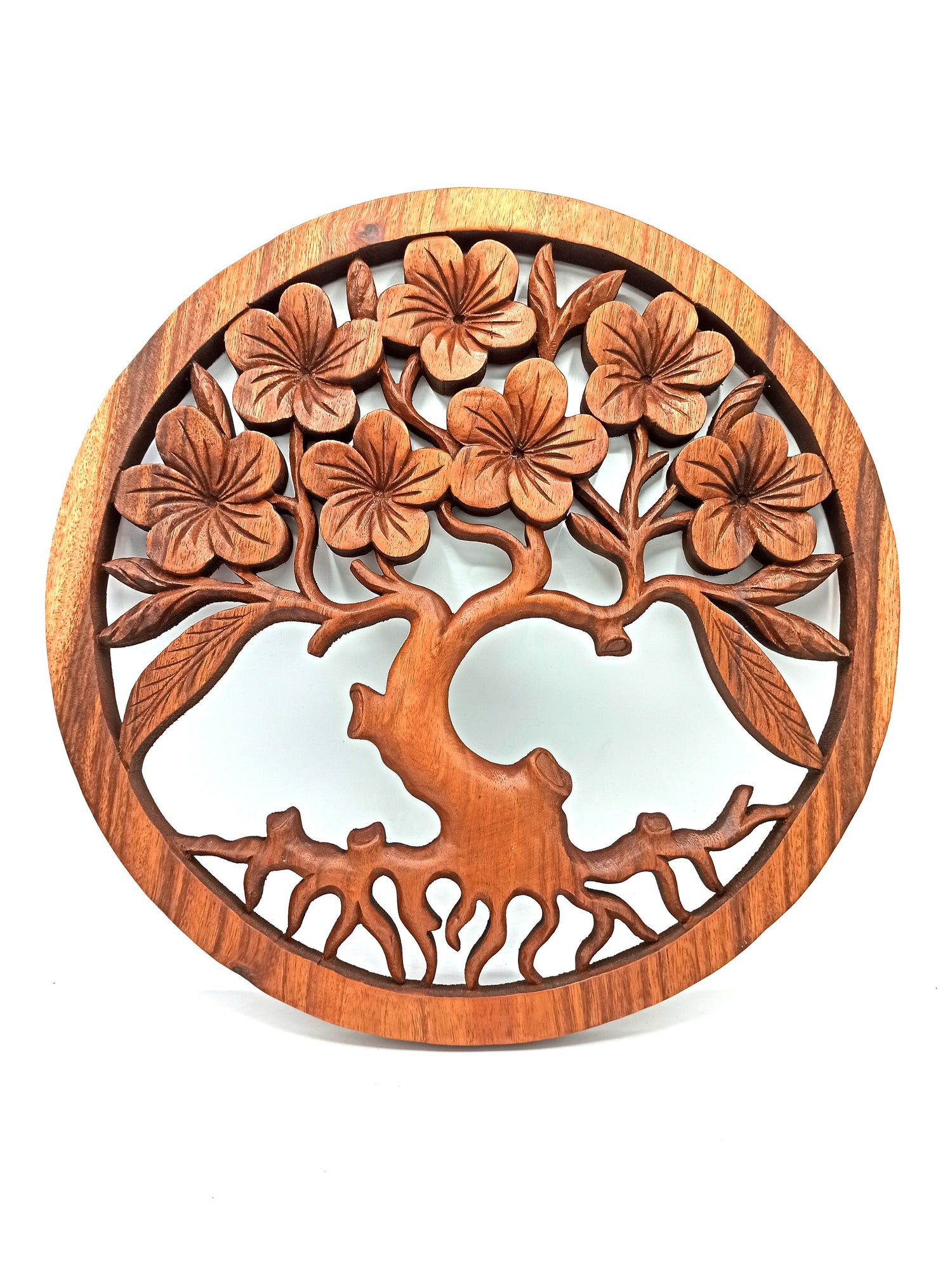 Wooden wall art with floral design on a white background