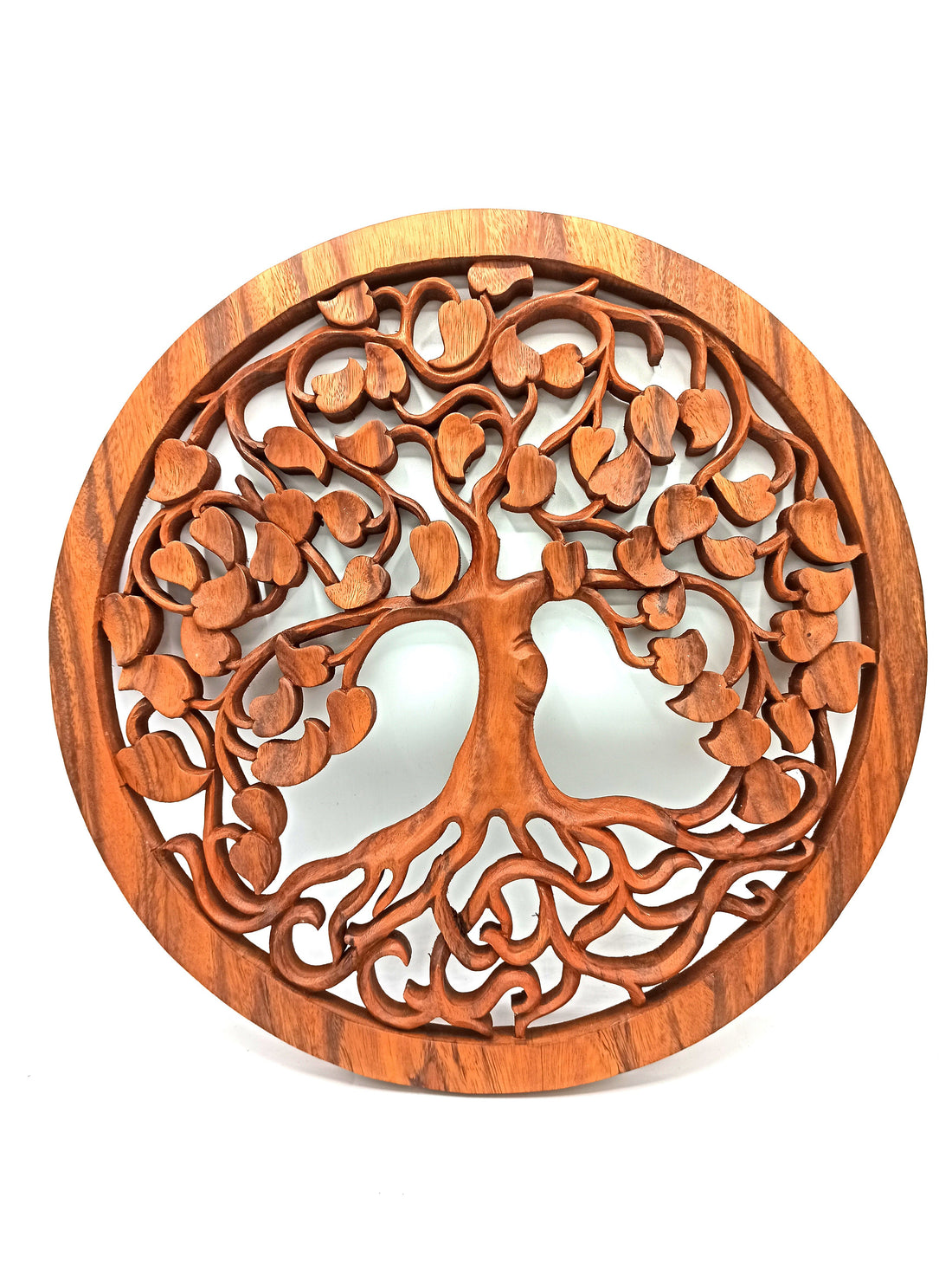 Wooden wall art with tree of life design on a white background