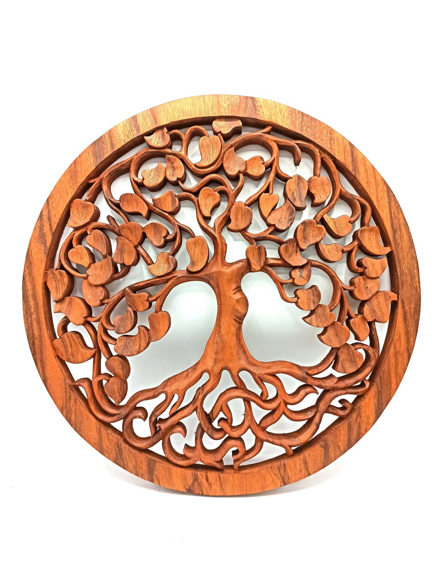 Wooden wall art with tree of life design on a white background