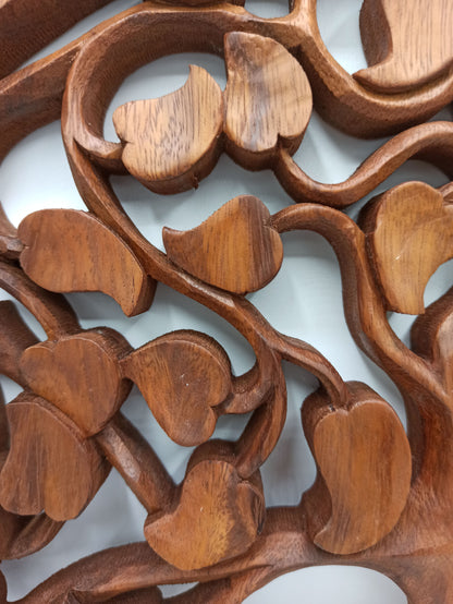 Close-up of a wooden carvings with floral patterns on a white background