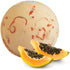 Bath bomb with papaya slices on a white background