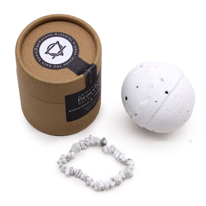 A white stone bracelet and bah bomb with a brown cardboard box on a white background