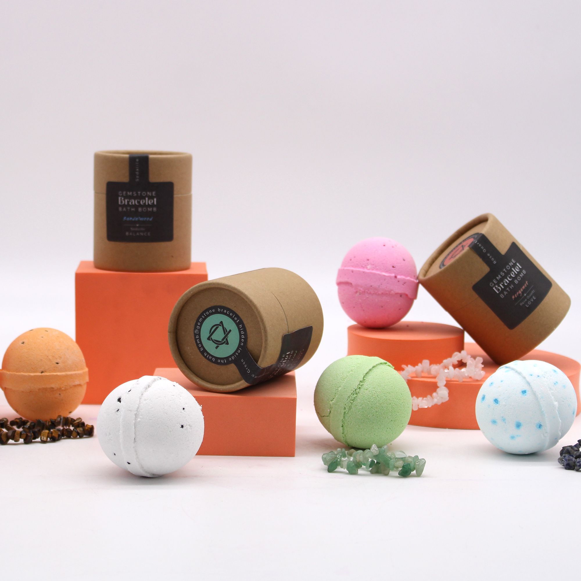Colorful bath bombs with their packaging on a white background