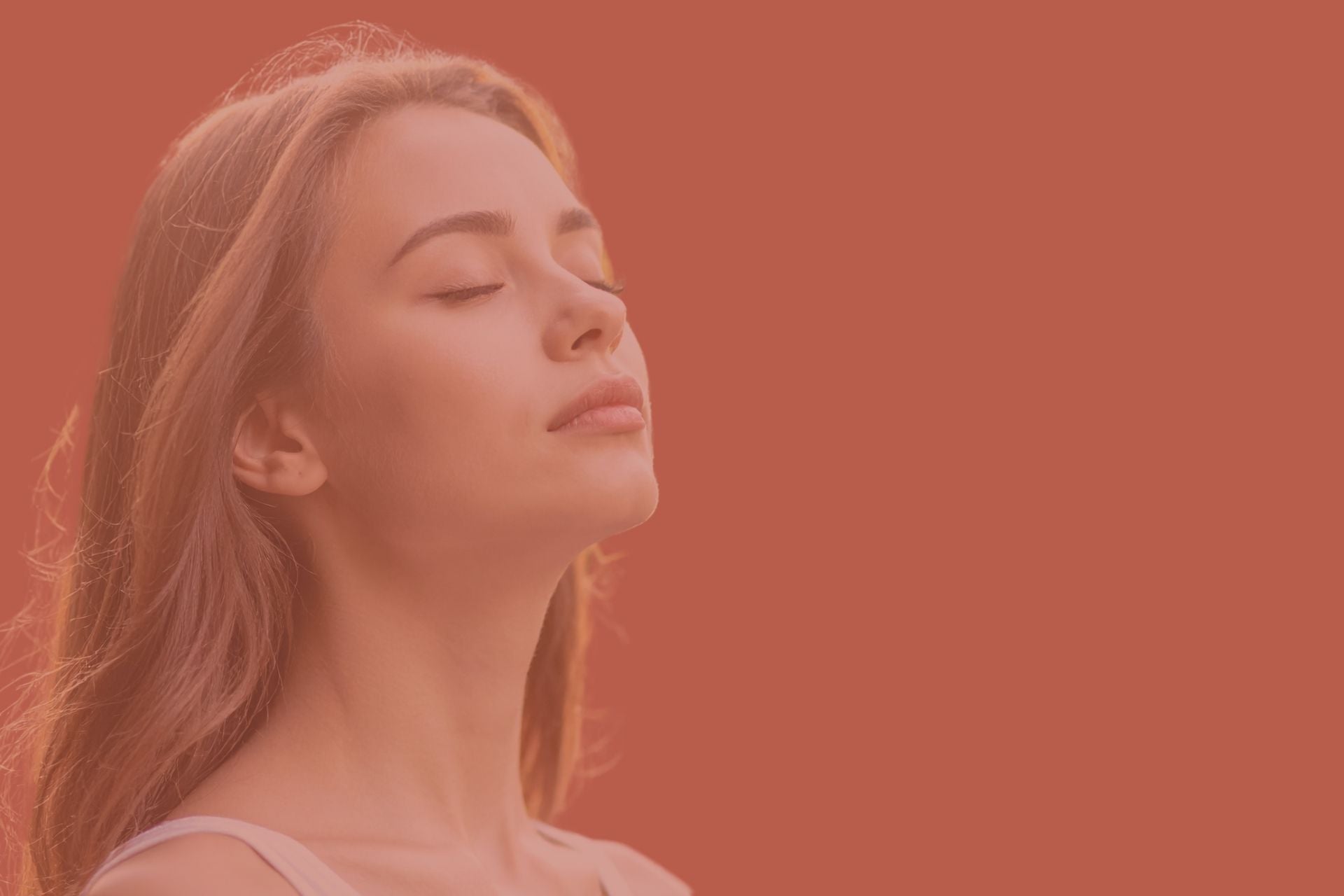 A woman with eyes closed, breathing through her nose